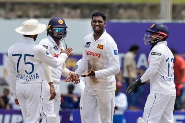 Nishan Peiris celebrates the wicket of Mitchell Santner